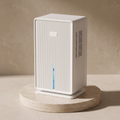 Ribbed compact dehumidifier in white on a travertine plinth